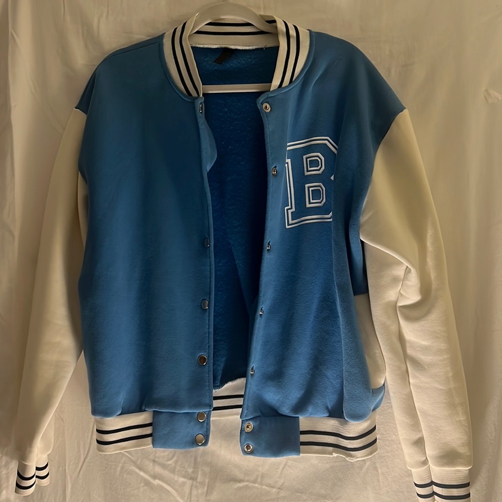 Varsity jacket,mostly blue/white along with black stripes on the sleeves/collar.